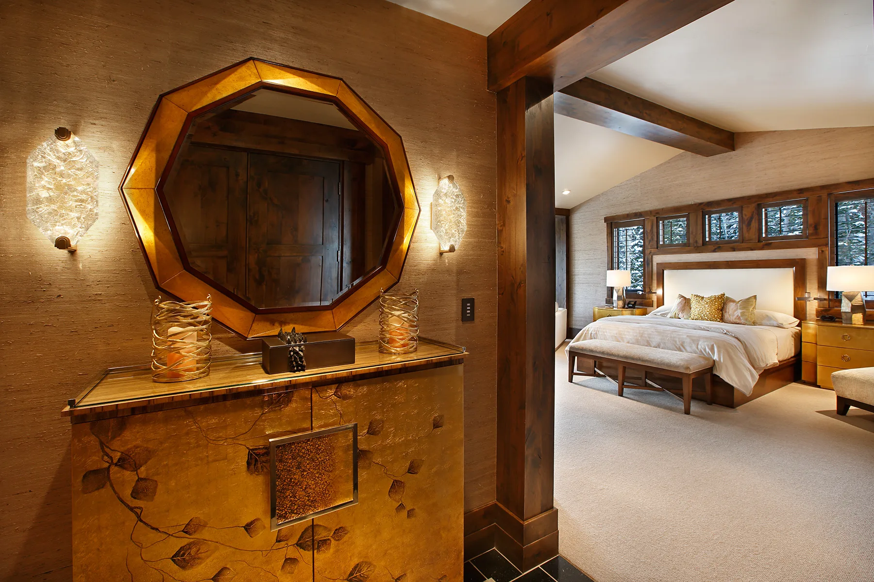 Bedroom with a round wood-framed mirror, a carved wood bed and a timber beam ceiling