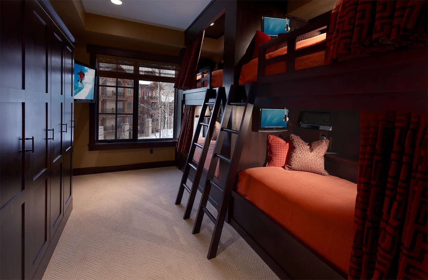 Bunk room with built-in bunk beds, a ladder and a window
