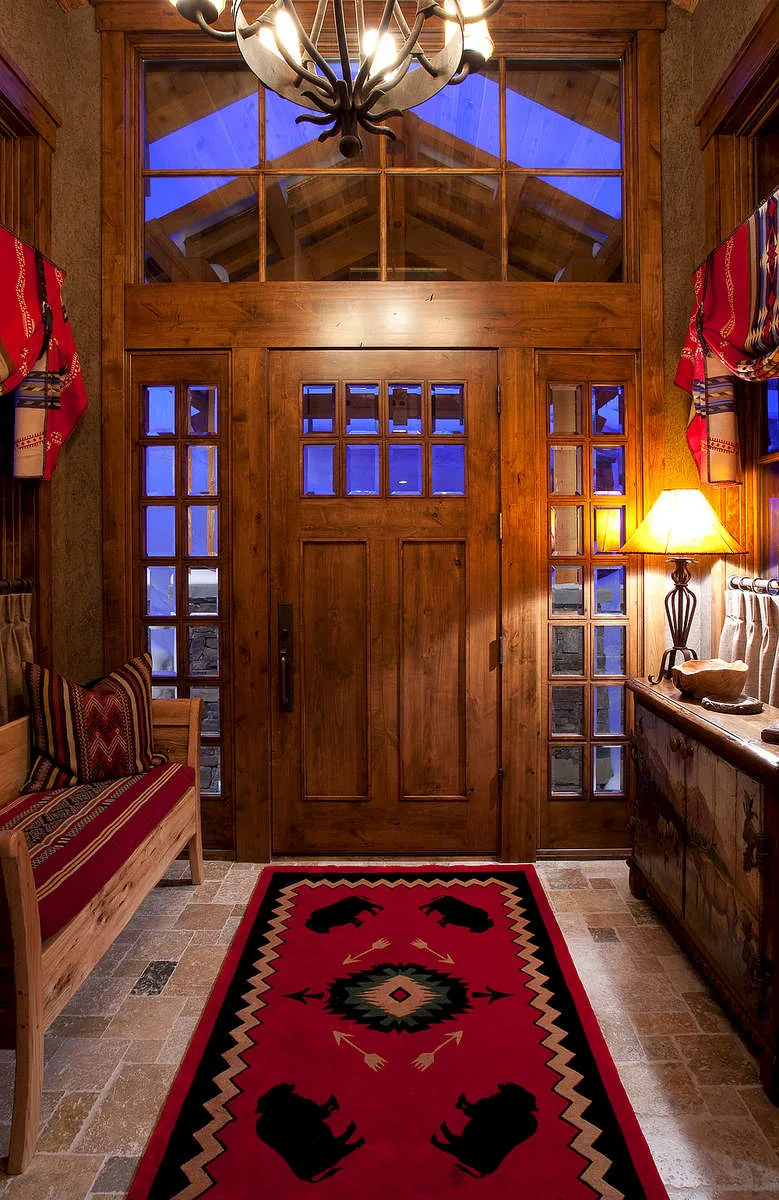 Front entry with a wood and glass door flanked by stained-glass sidelights