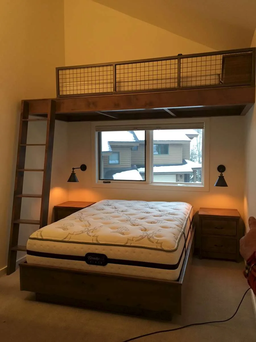 Bedroom with beige bedding and patterned throw pillows