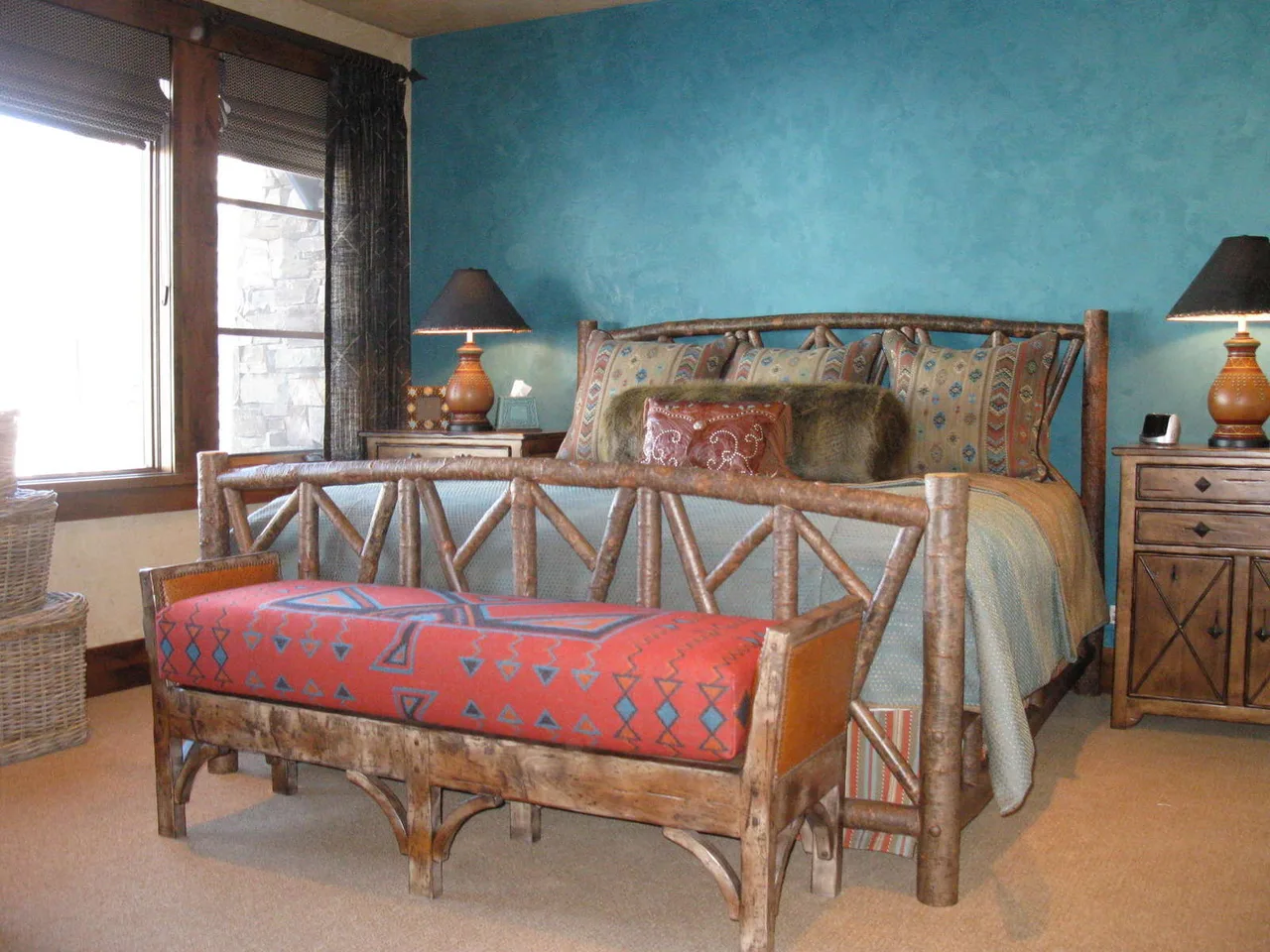 Wood bench with a southwestern patterned cushion against a blue accent wall and window