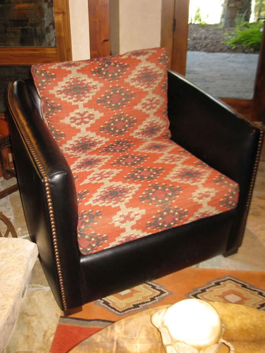Leather armchair with a southwestern patterned seat cushion