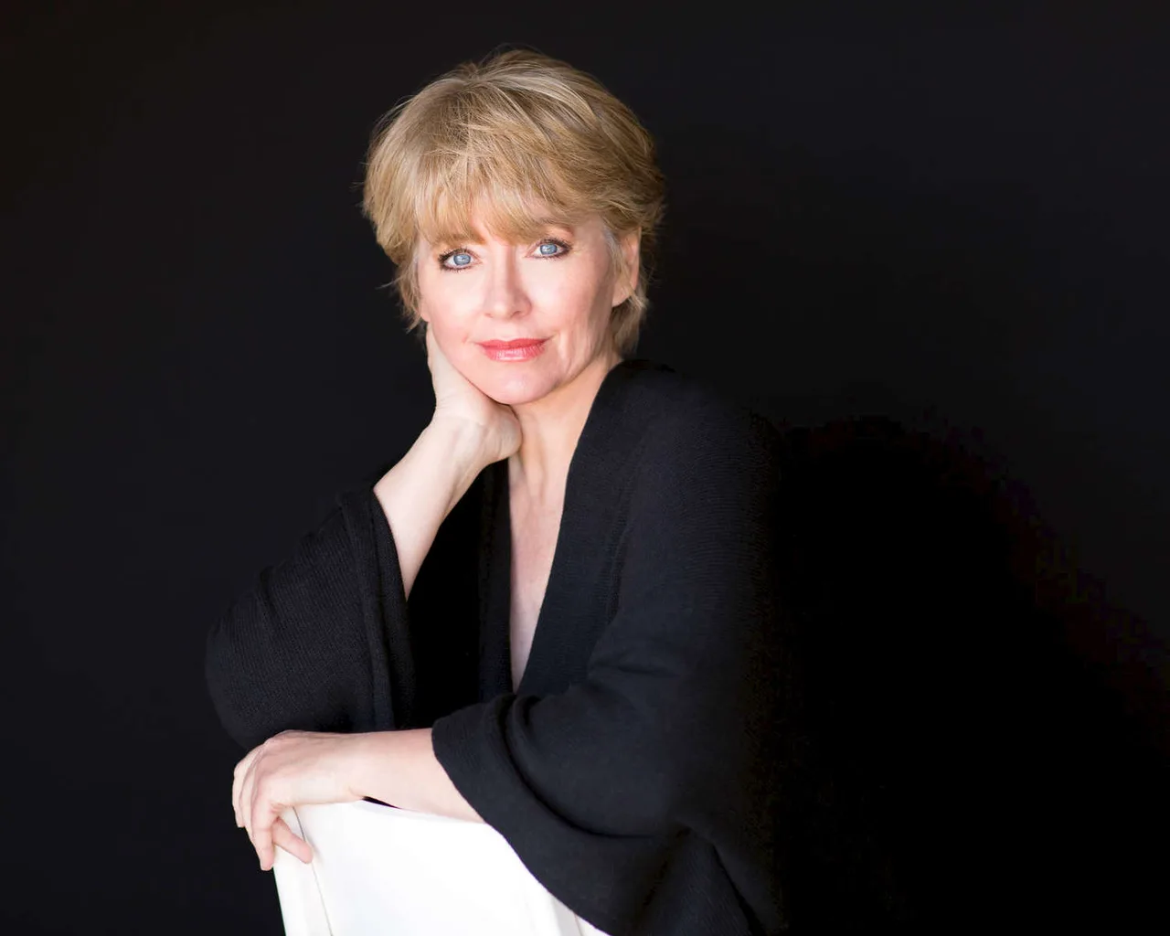 Headshot portrait of SuAnne Smith against a dark background
