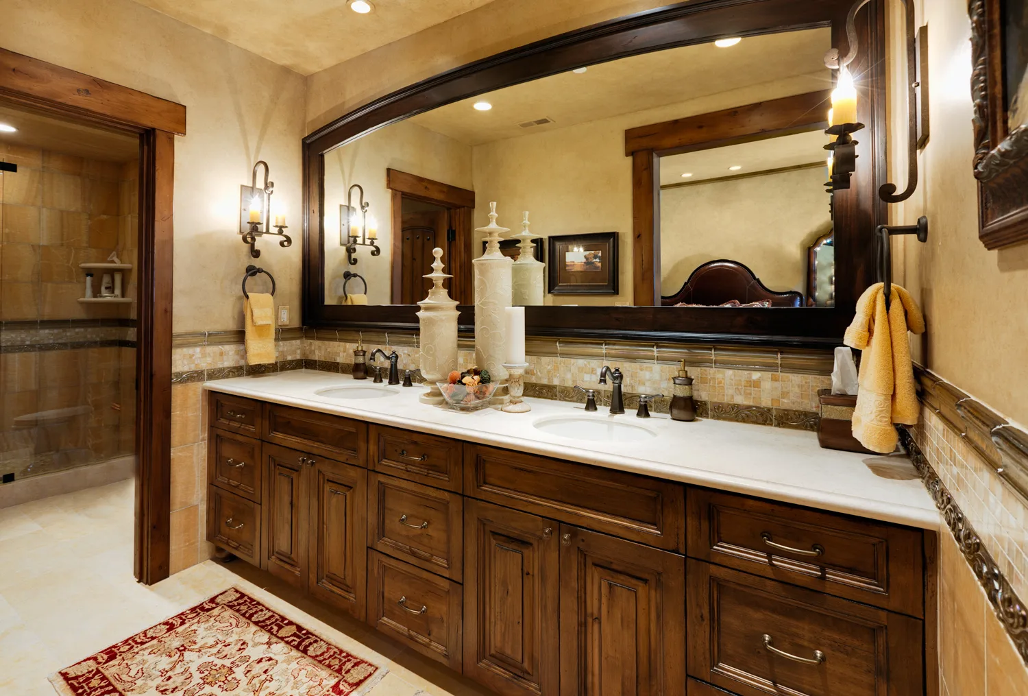 Bathroom with a long dark wood double vanity and a large mirror
