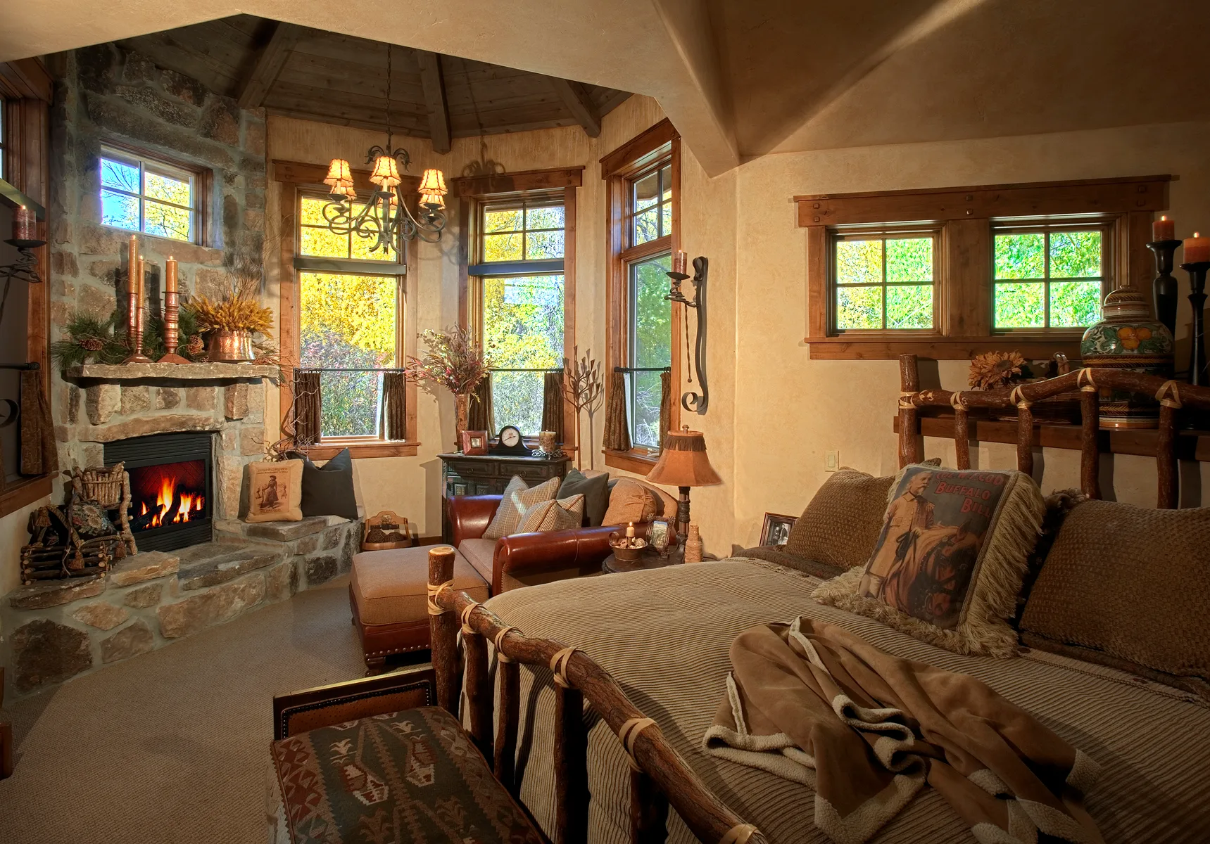 Bedroom sitting area with a stone fireplace and a bay window seat