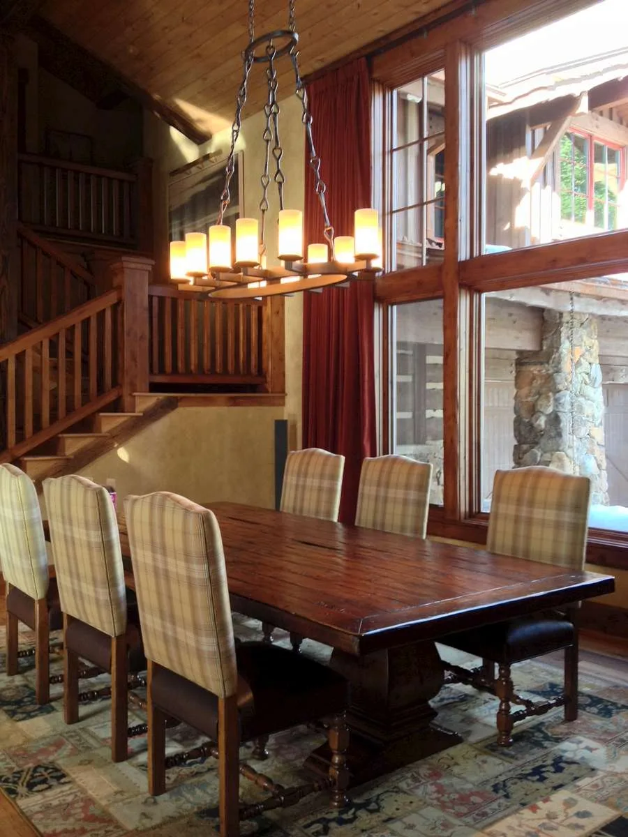 Dining nook with framed art, a table and chairs near a staircase