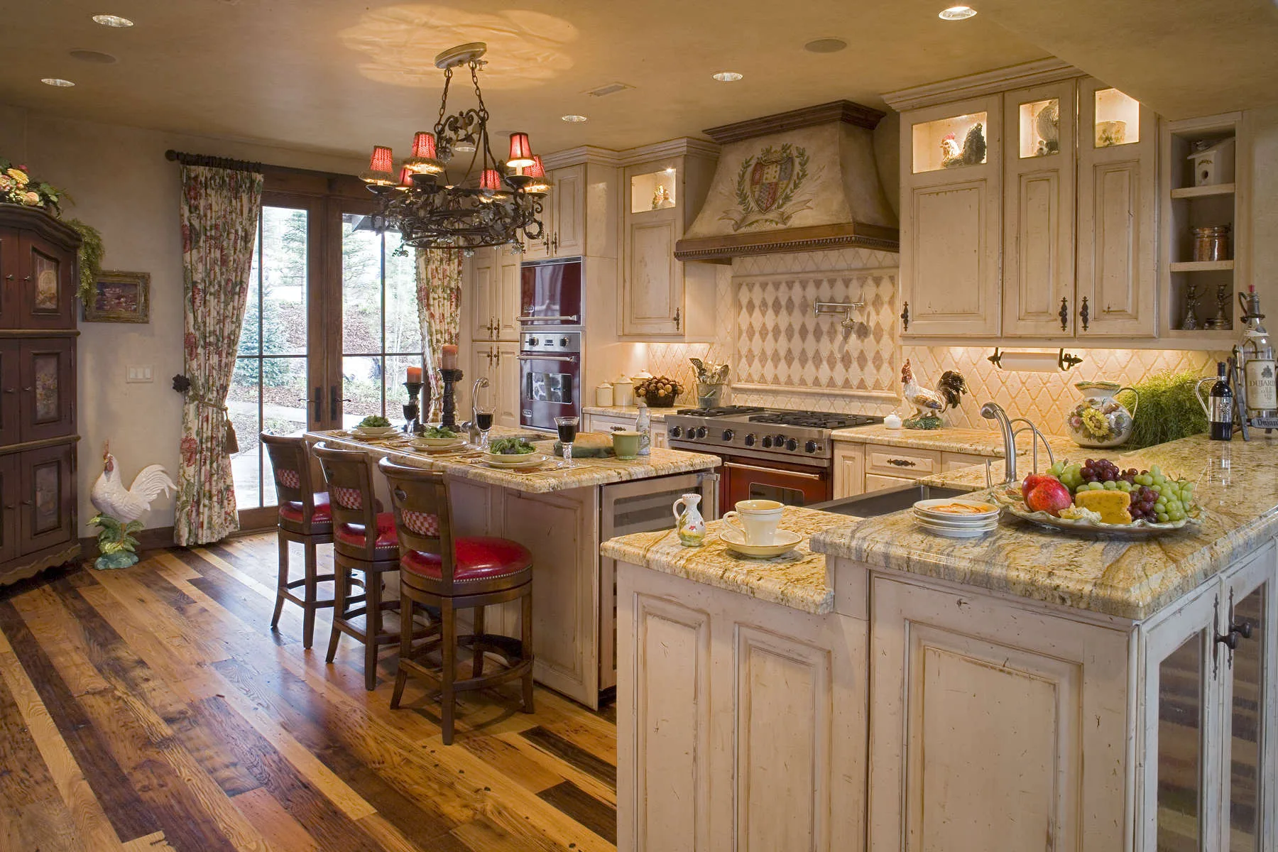 Kitchen with wood cabinetry, an island with bar stools and pendant lights