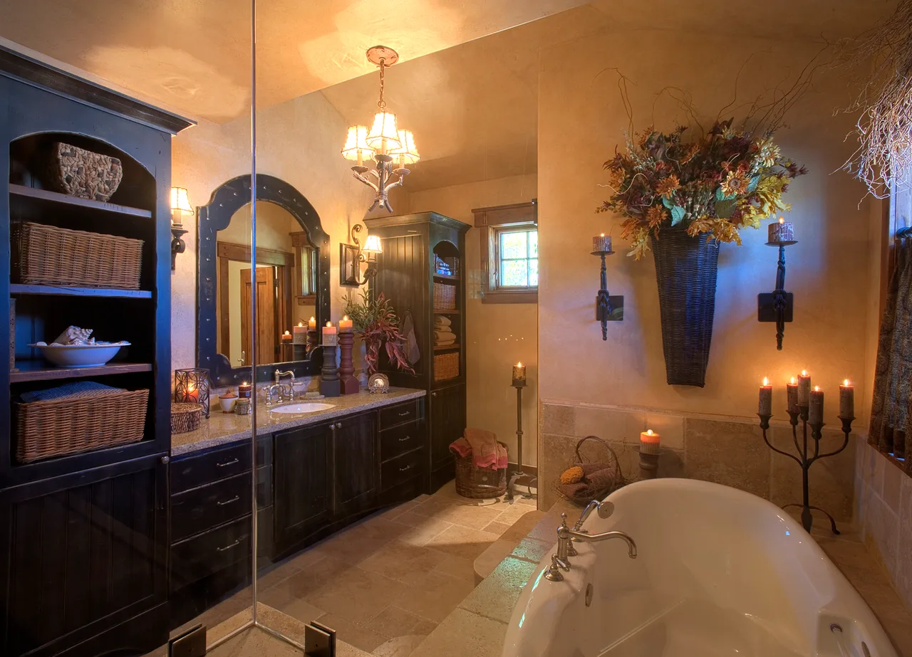 Bathroom and closet area with a dark wood vanity, mirror and woven baskets