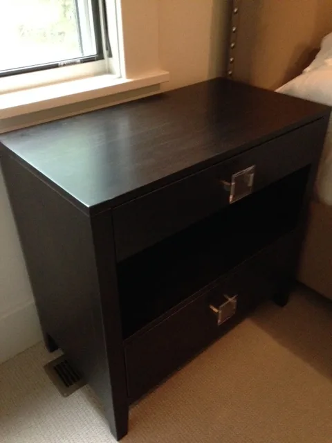 Custom dark wood blanket chest at the foot of a bed