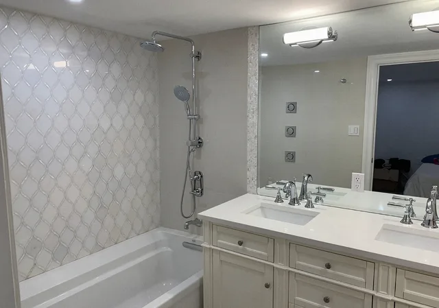 Basement bathroom after the remodel, with a double vanity and rain shower