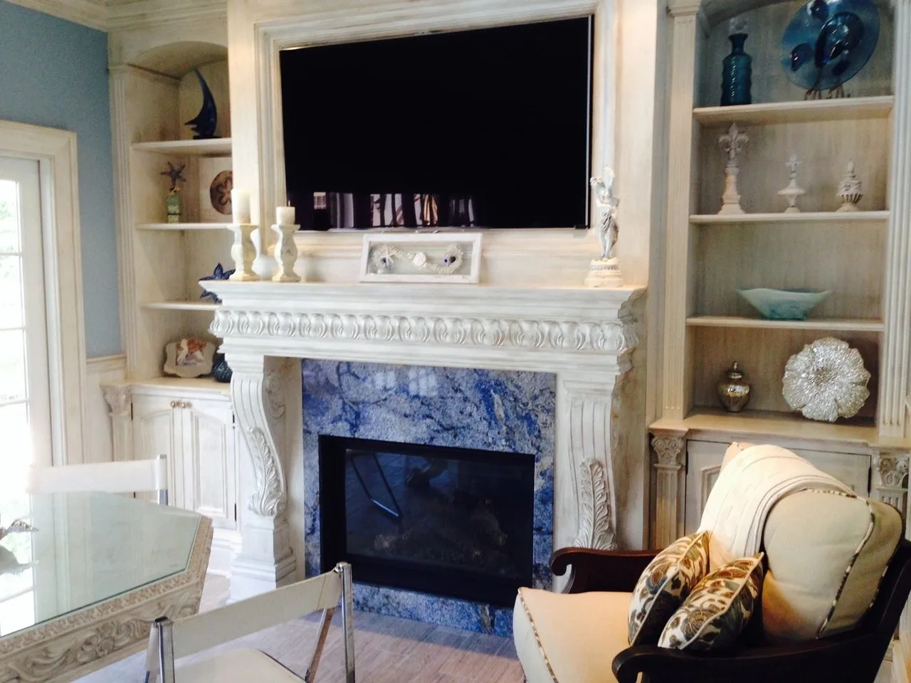 white carved fireplace with blue stone and shelves, Built-Ins & Furniture