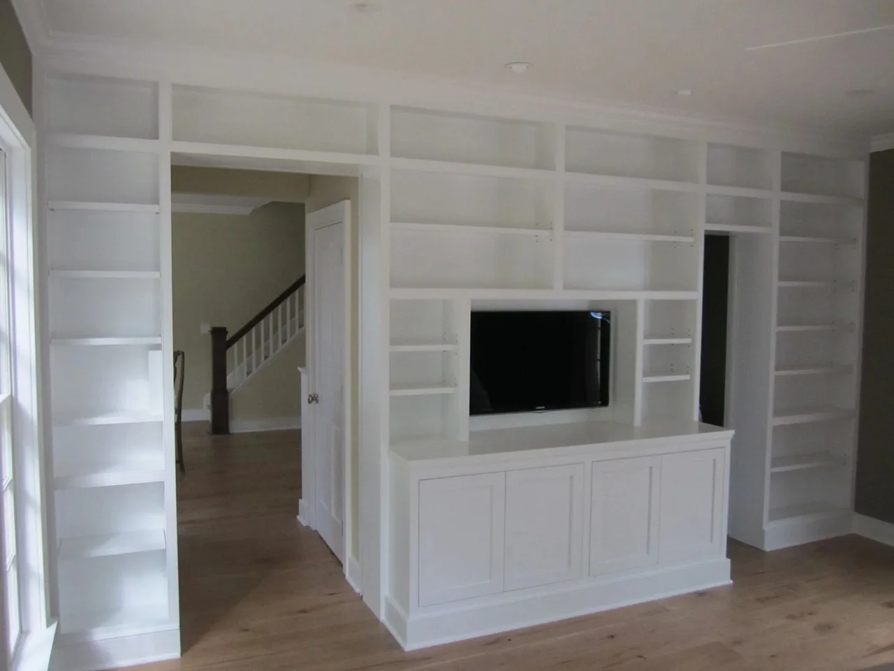 white built-in shelving around doorway and TV, Kitchens & Vanities