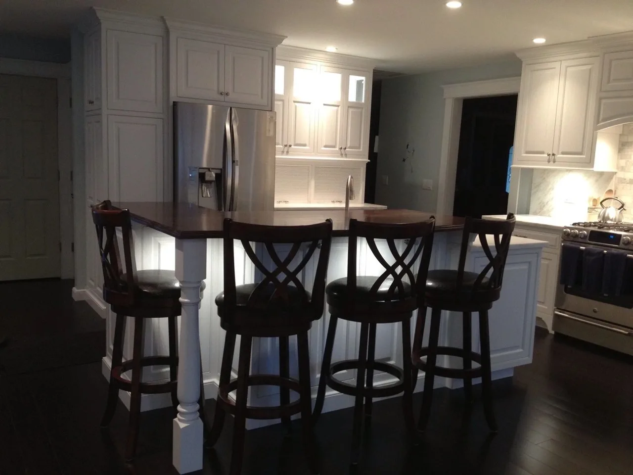 white kitchen with dark stools and wood floor, Kitchens & Vanities